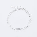 Sterling silver bracelet featuring several shiny rectangular rings with a hammered finish by Gexist®